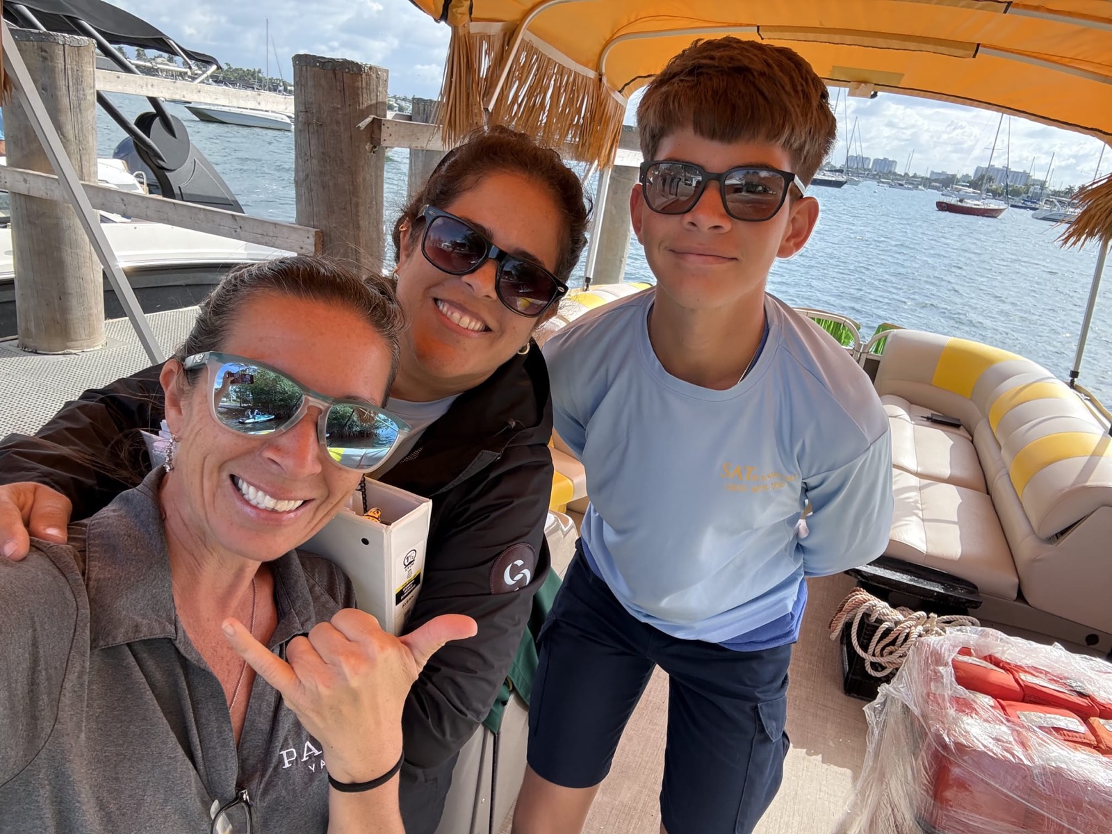 Captain Ro, First Mate Brandon, and family aboard the Tiki Paradiso